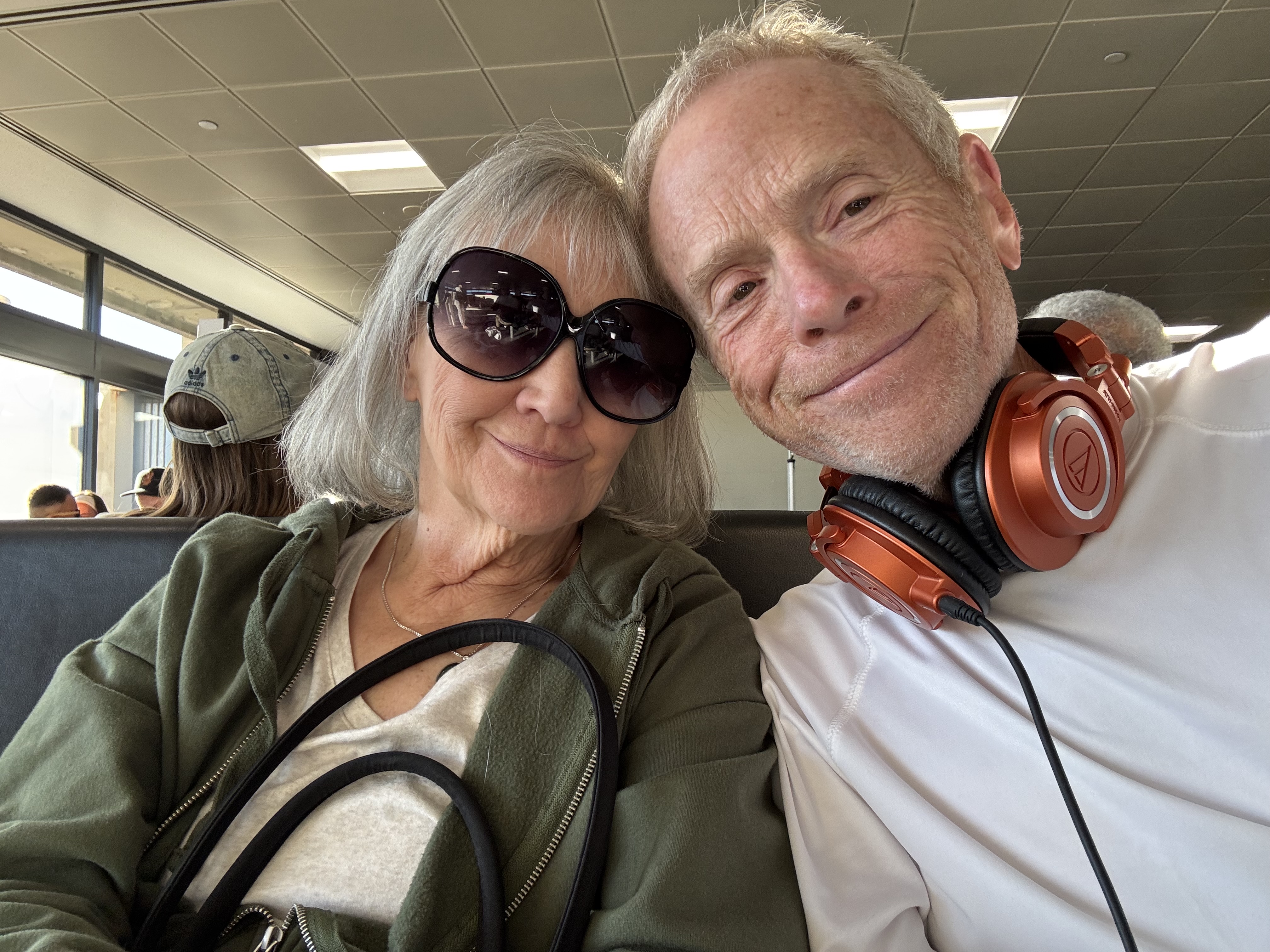 Bob Massie and Diana together at the airport, smiling.